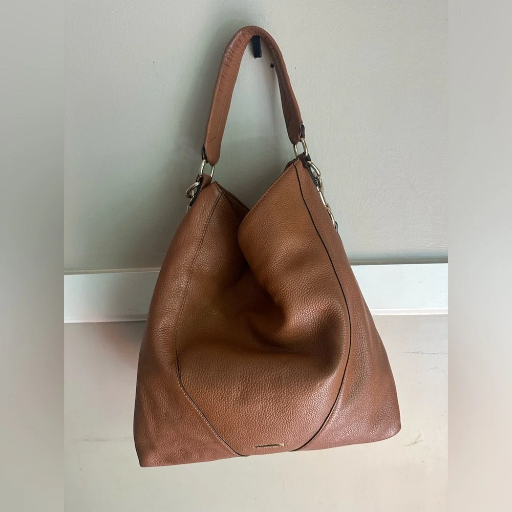 Rebecca Minkoff Moto hobo bag featuring prominent vertical zippers on the front.
